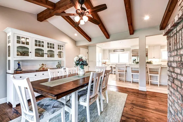 a kitchen with granite countertop white cabinets and window