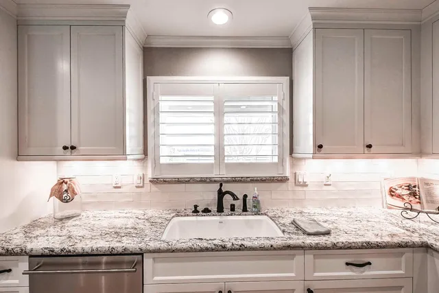 a bathroom with double vanity sinks a vanity a lamp and a mirror
