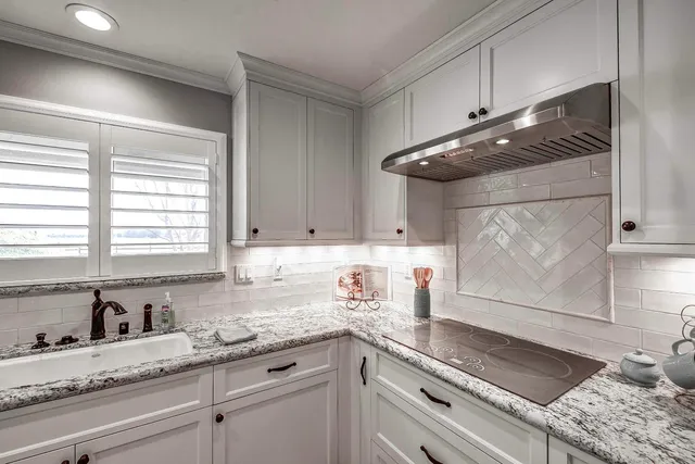 a bathroom with a tub sink and window