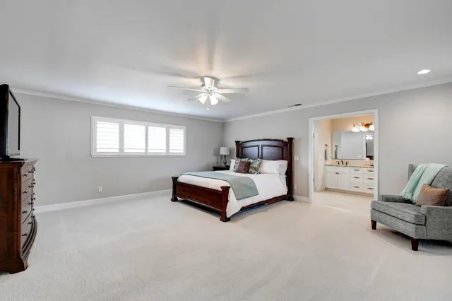 a bathroom with a granite countertop double vanity sink a mirror and a shower