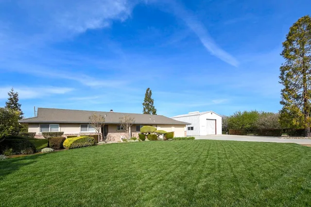 a front view of a house with a garden