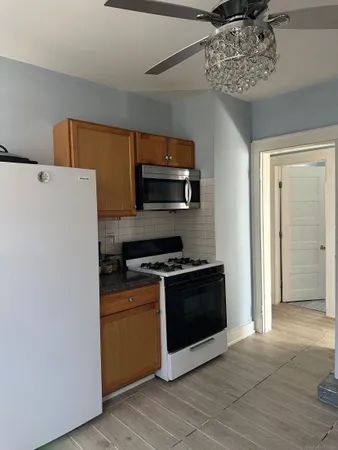 a kitchen with stainless steel appliances a stove a microwave and a refrigerator