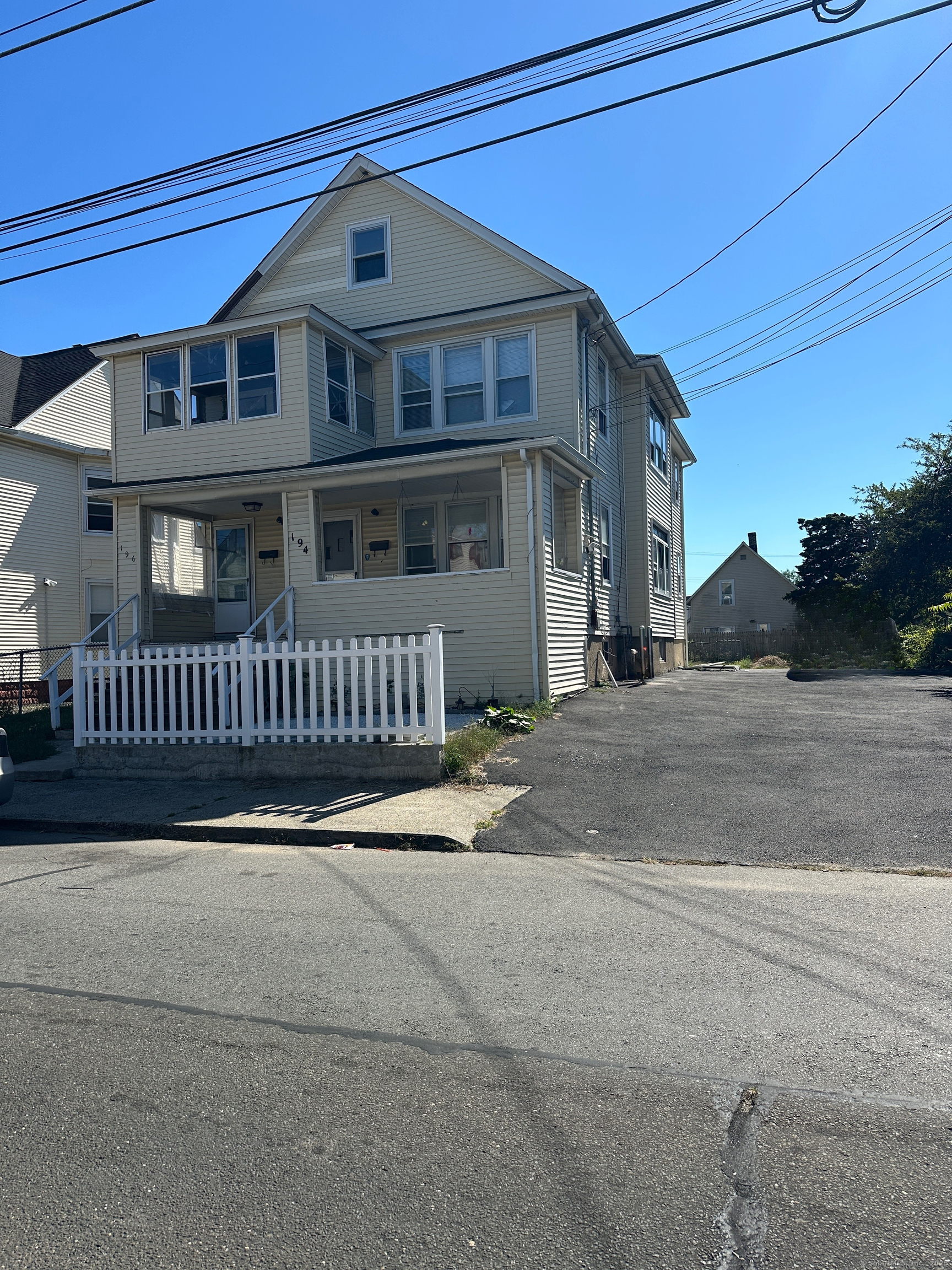 194 Adams Street Bridgeport, CT 06607 - Photo 2 of 17 a front view of a house with fence