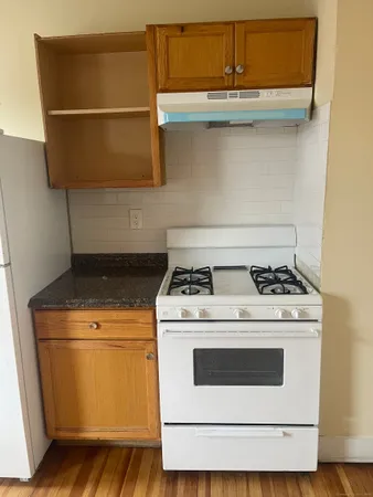 a stove top oven sitting inside of a kitchen