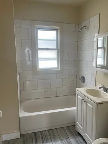 a bathroom with a sink a bathtub and a shower