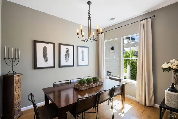 a living room with furniture kitchen view and a large window