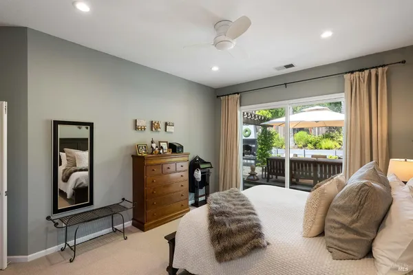 a bedroom with a bed and painting on the wall