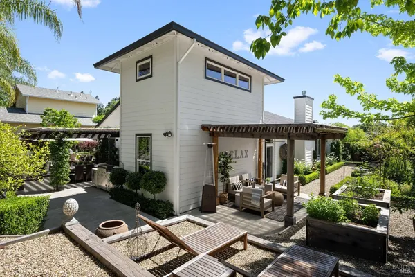 a view of a chairs and table in backyard