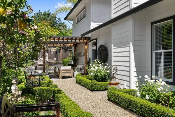 a view of a chairs and table in backyard