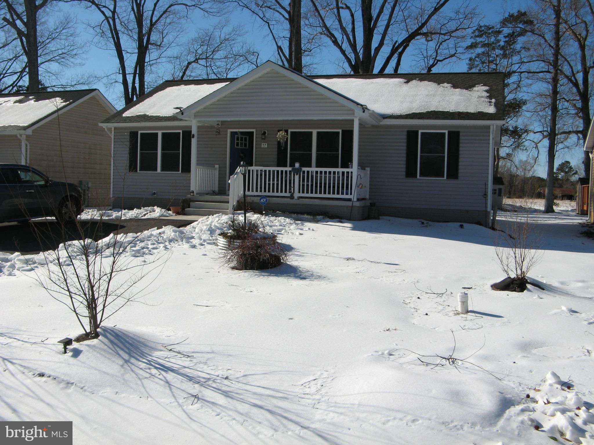 57 Oak Lane Colonial Beach, VA 22443 - Photo 1 of 47 a view of a house with snow on the road