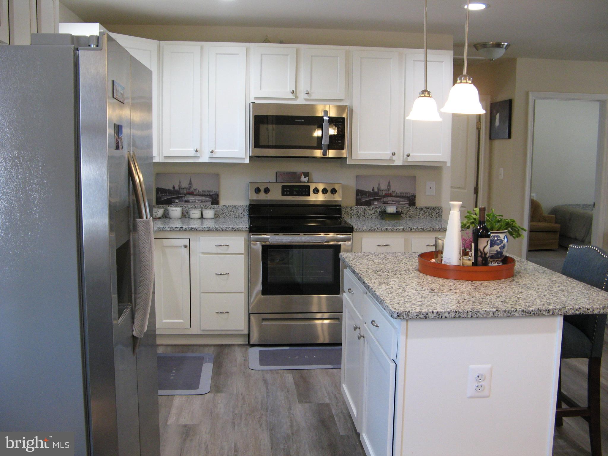57 Oak Lane Colonial Beach, VA 22443 - Photo 20 of 47 a kitchen with granite countertop a sink stove and refrigerator