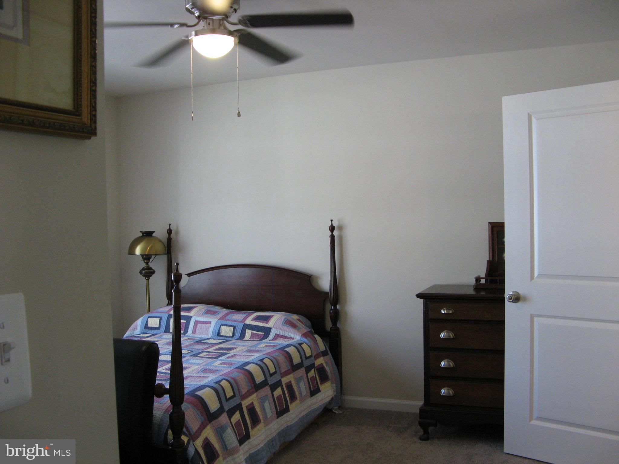 57 Oak Lane Colonial Beach, VA 22443 - Photo 23 of 47 a bedroom with a bed and a chandelier