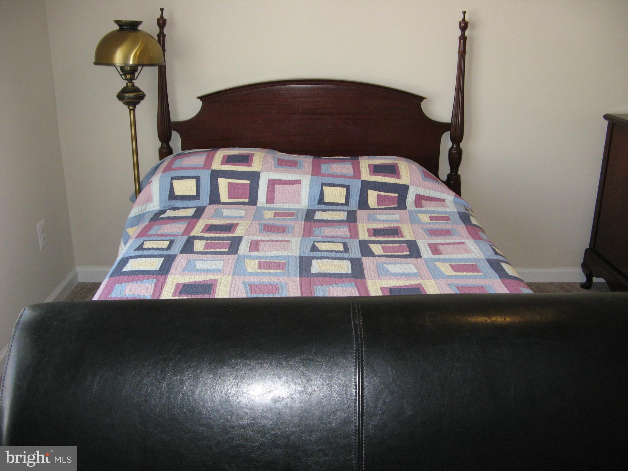 57 Oak Lane Colonial Beach, VA 22443 - Photo 24 of 47 a blue bed sitting in a bedroom next to a window