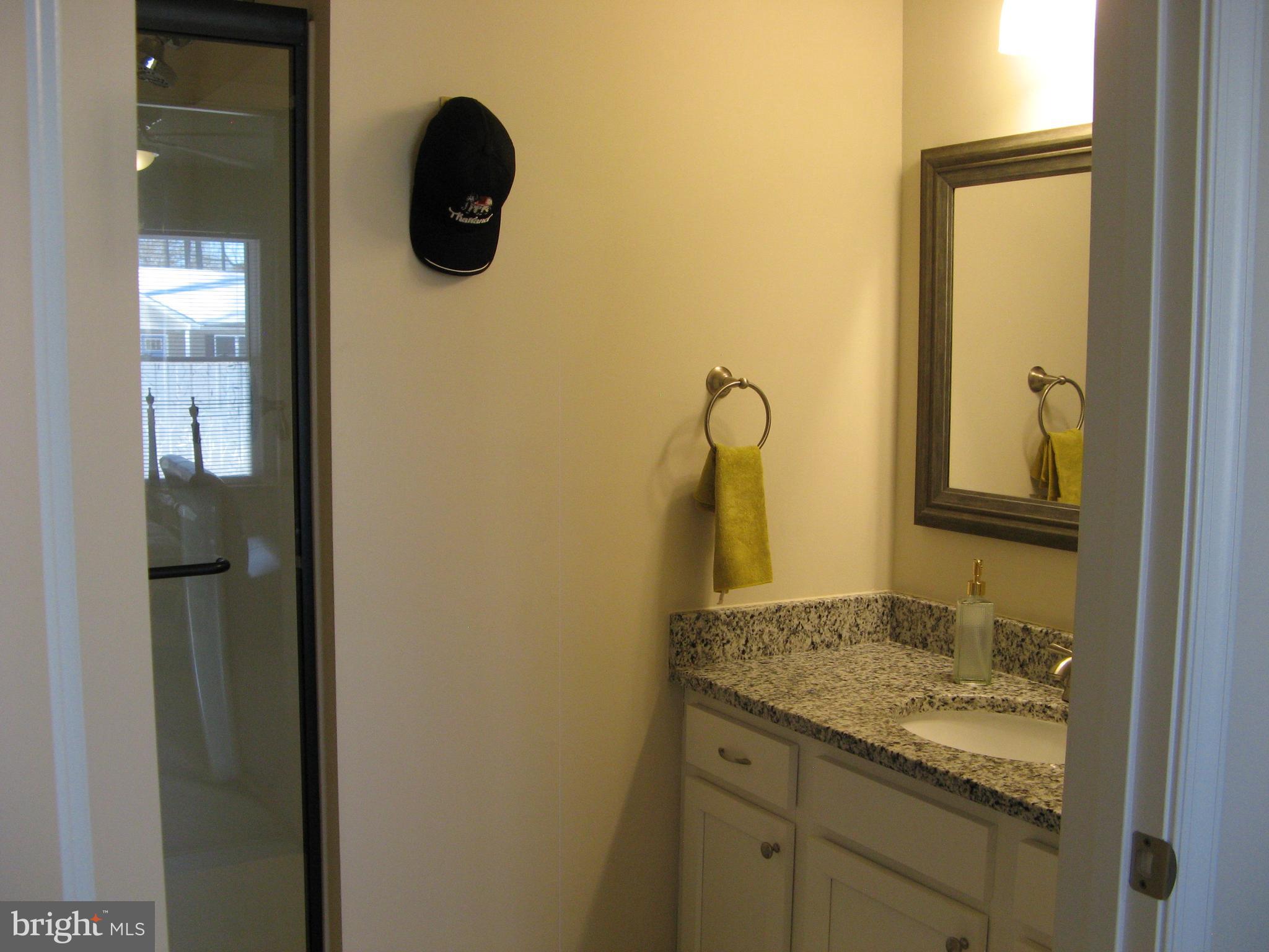 57 Oak Lane Colonial Beach, VA 22443 - Photo 27 of 47 a bathroom with a granite countertop sink and a mirror