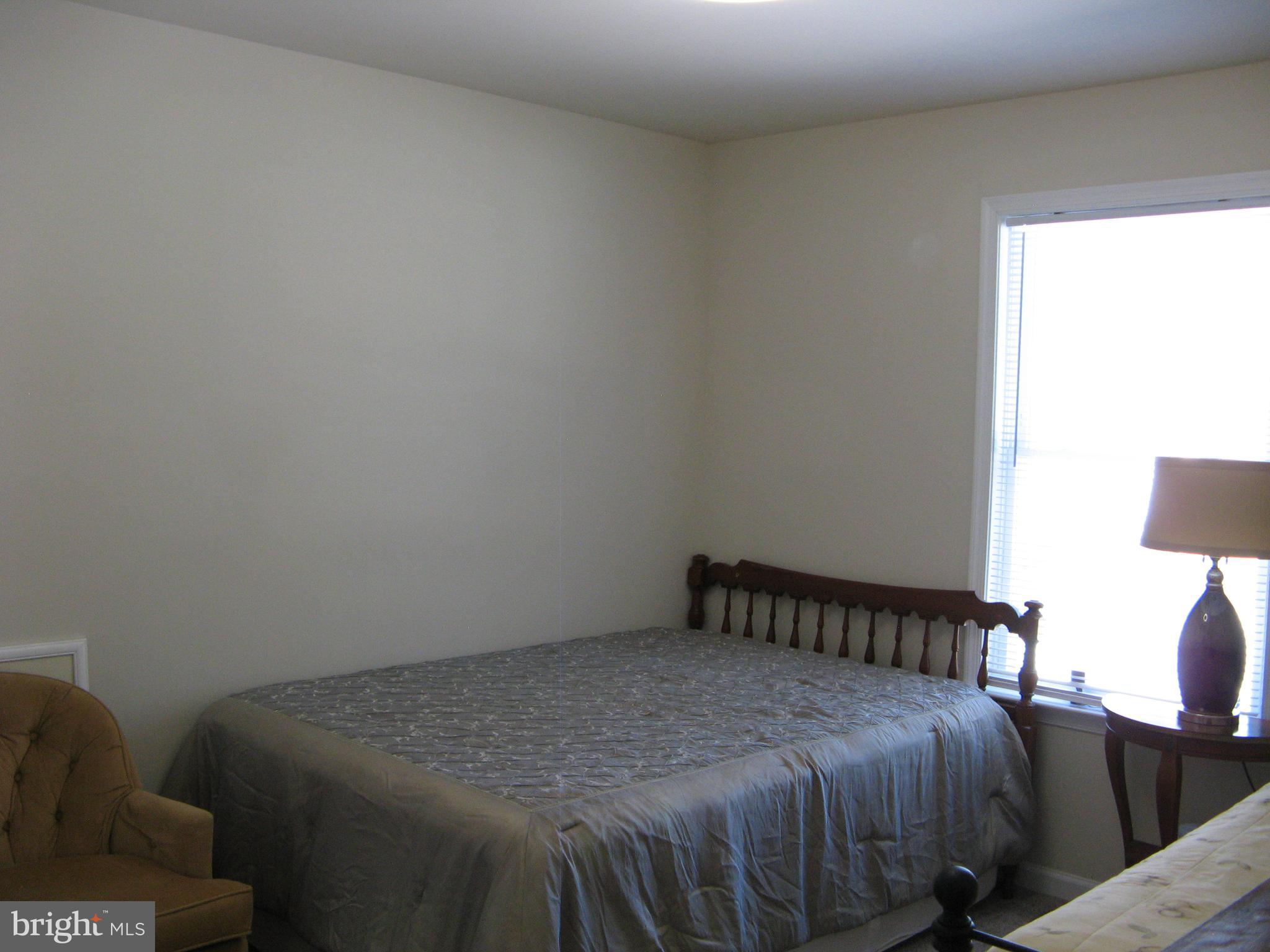 57 Oak Lane Colonial Beach, VA 22443 - Photo 29 of 47 a bed sitting in a bedroom next to a window