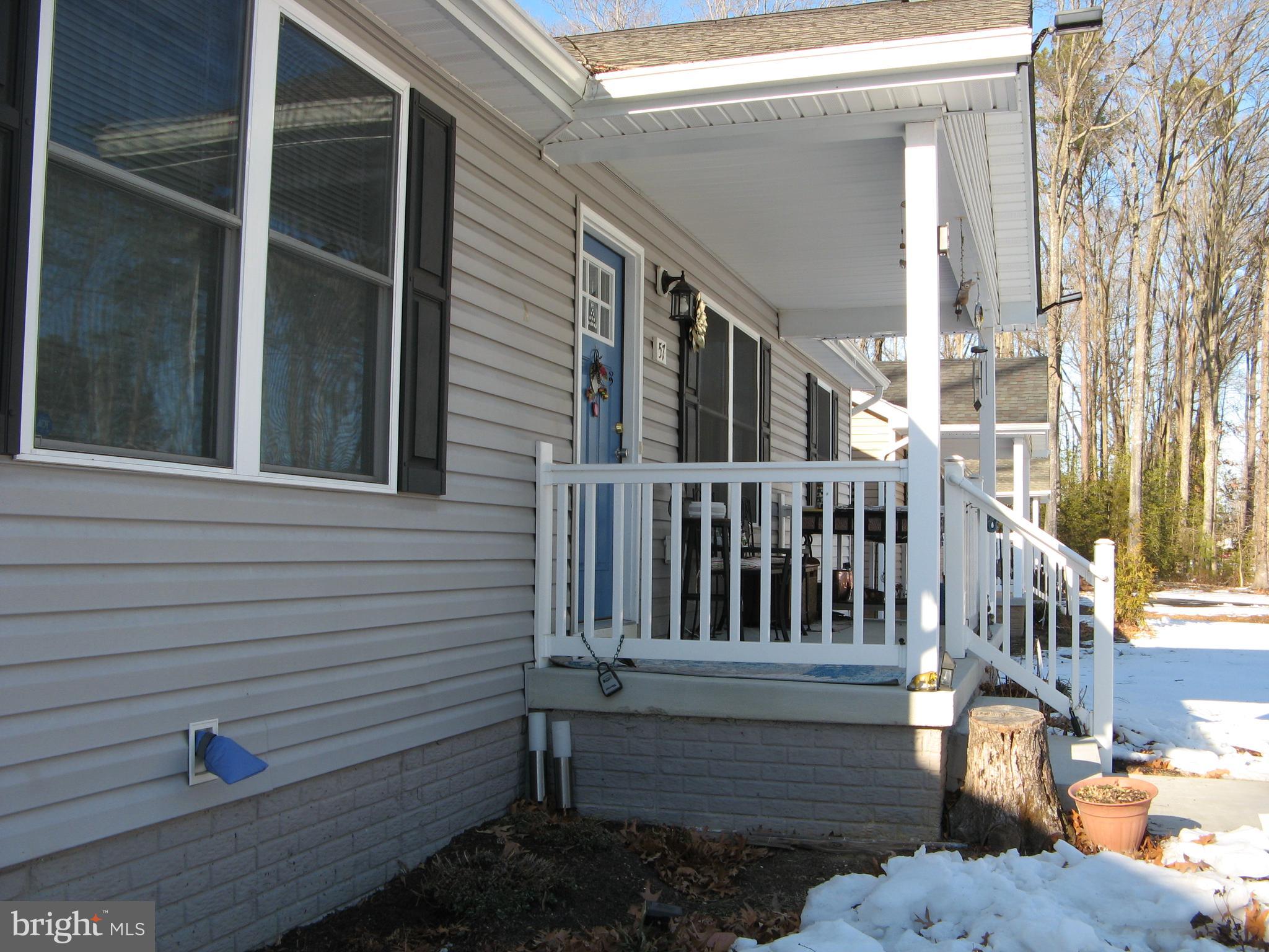 57 Oak Lane Colonial Beach, VA 22443 - Photo 4 of 47 a view of a house with a small yard and wooden floor and fence