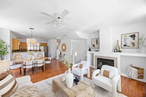 a living room with furniture fireplace and a chandelier