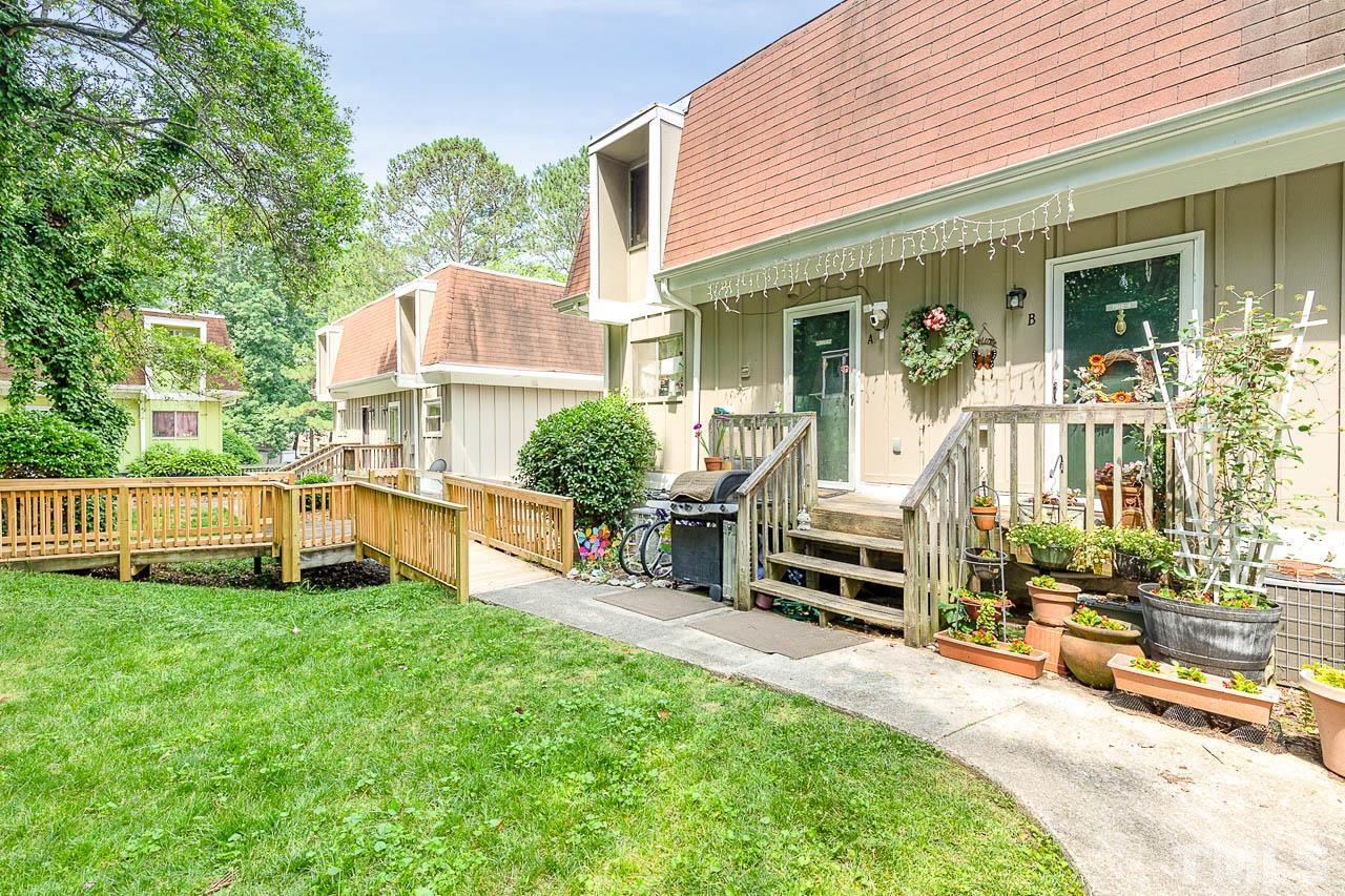 7010 Longstreet Drive, Unit B Raleigh, NC 27615 - Photo 1 of 18 front view of a house with a yard and porch