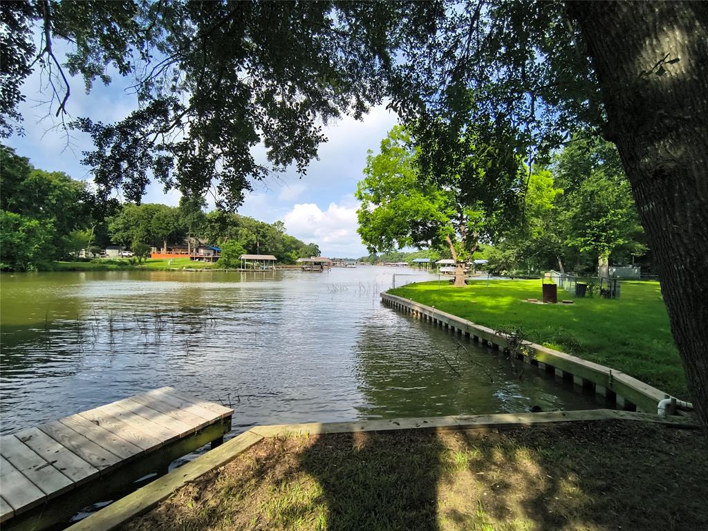 180 Arrowhead Street Mabank, TX 75156 - Photo 20 of 26 a view of a lake with a yard and large trees