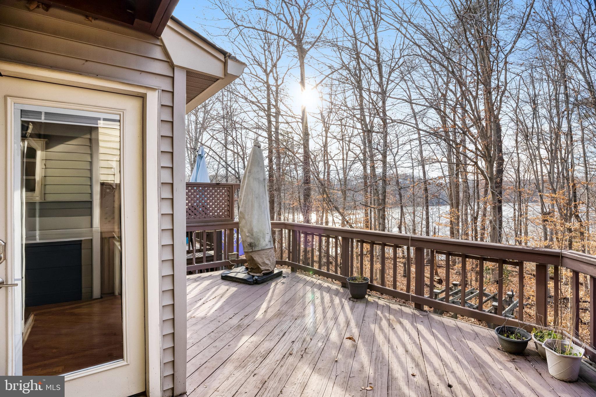 8046 Galla Knoll Circle Springfield, VA 22153 - Photo 12 of 38 a view of a balcony with wooden floor and furniture