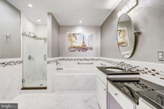 a bathroom with a bathtub a mirror a sink and a window