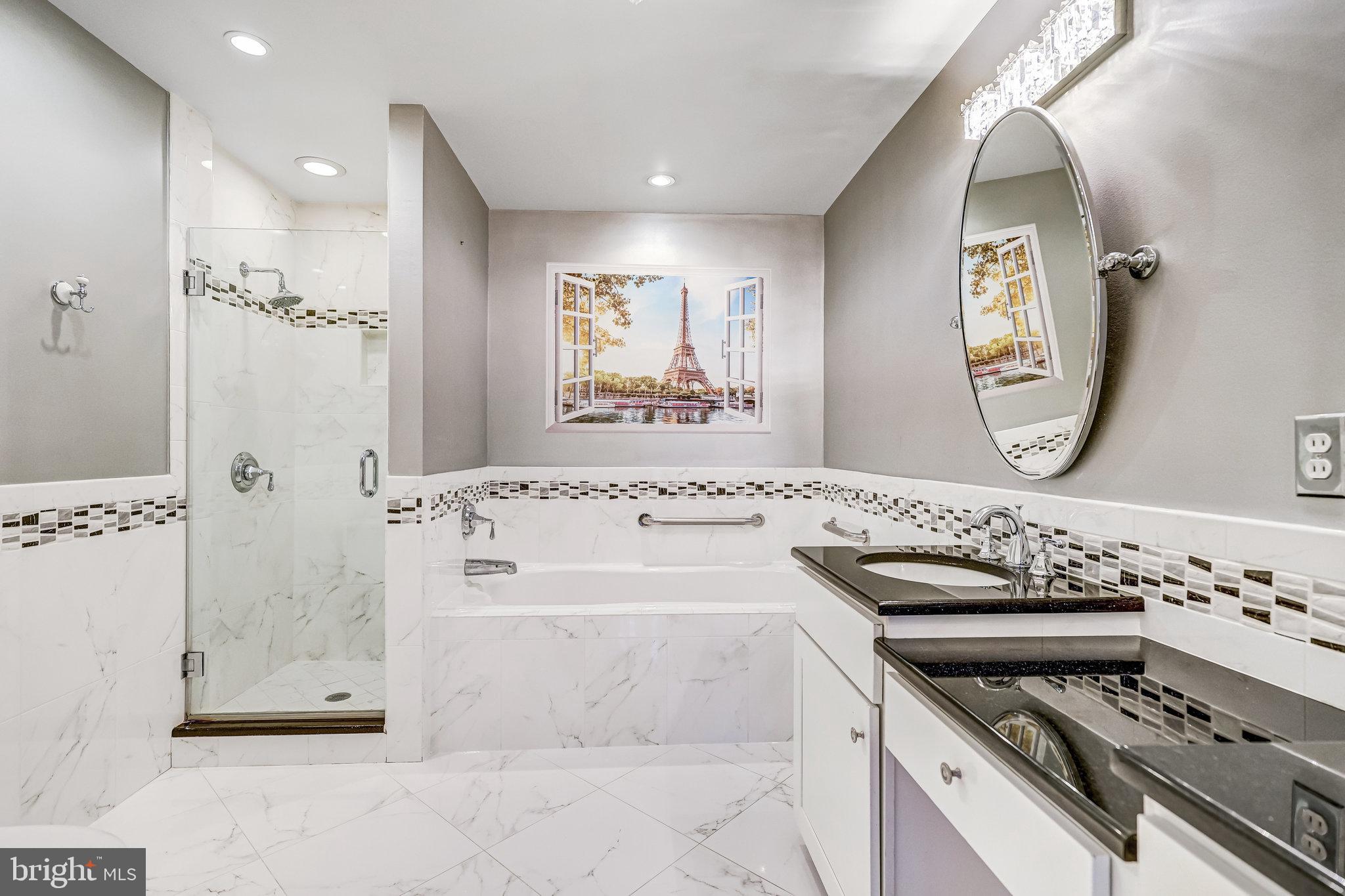 8046 Galla Knoll Circle Springfield, VA 22153 - Photo 17 of 38 a bathroom with a bathtub a mirror a sink and a window