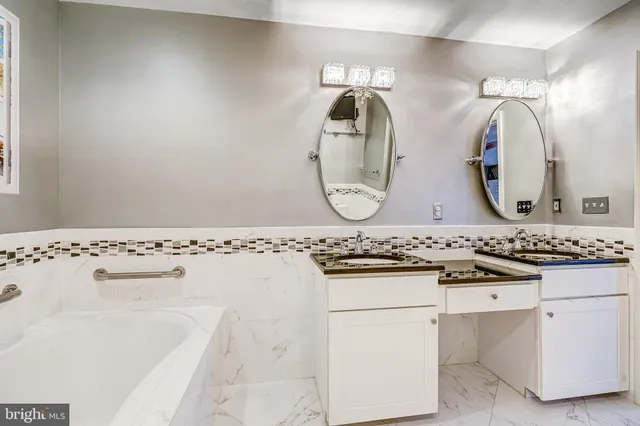 a bathroom with a granite countertop sink a mirror and a shower