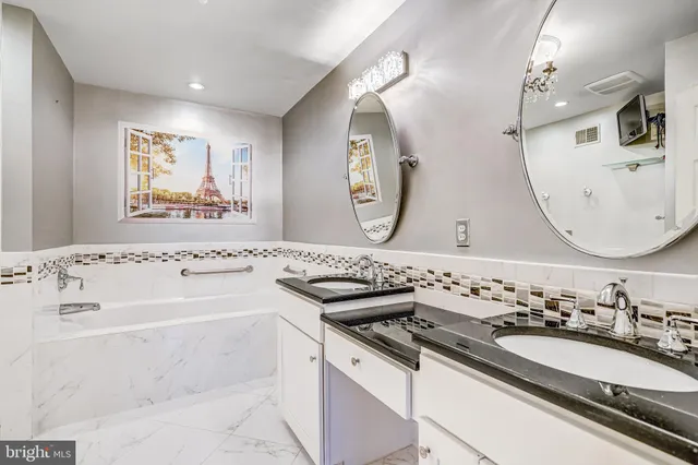 a bathroom with a bathtub and a mirror