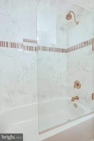 a bathroom with a shower and a bathtub