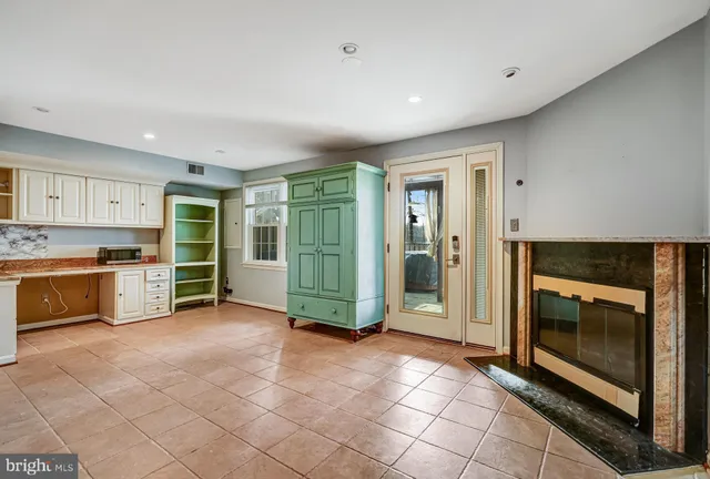 a view of a kitchen with an entryway and a stove top oven