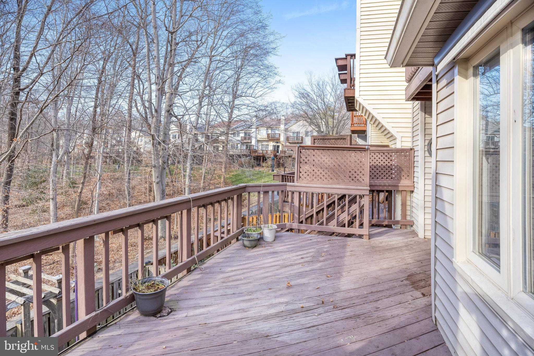 8046 Galla Knoll Circle Springfield, VA 22153 - Photo 33 of 38 a view of a balcony with chairs and wooden floor