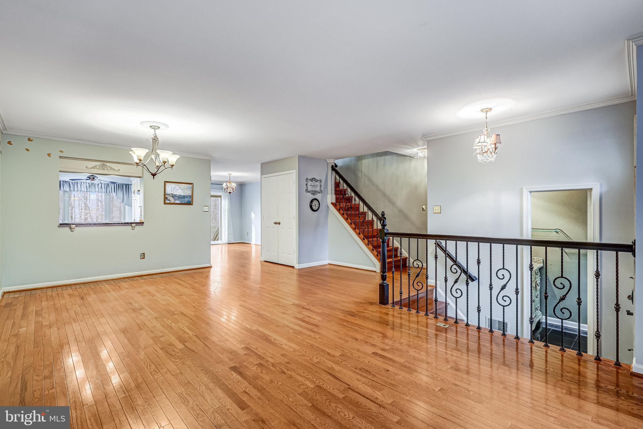 8046 Galla Knoll Circle Springfield, VA 22153 - Photo 5 of 38 a view of a hallway with wooden floor and staircase