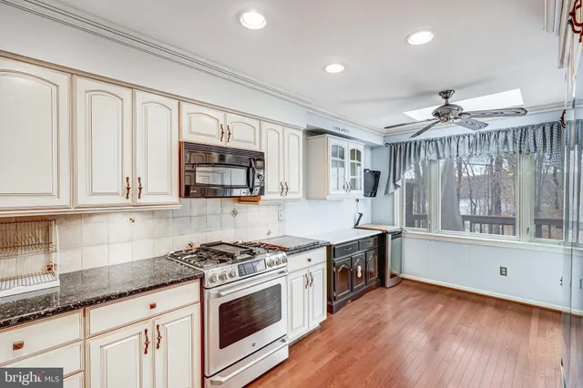 a kitchen with granite countertop a stove and a sink