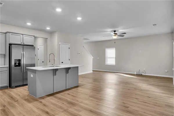 a view of kitchen with cabinets appliances and wooden floor