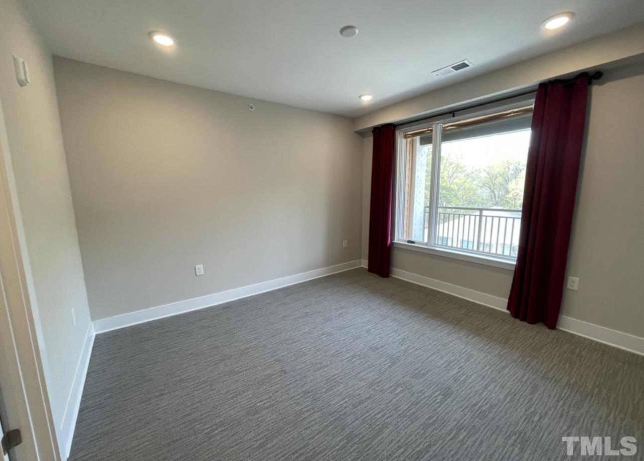 105 Chatham Walk Lane, Unit 404 Cary, NC 27511 - Photo 11 of 33 an empty room with wooden floor and windows