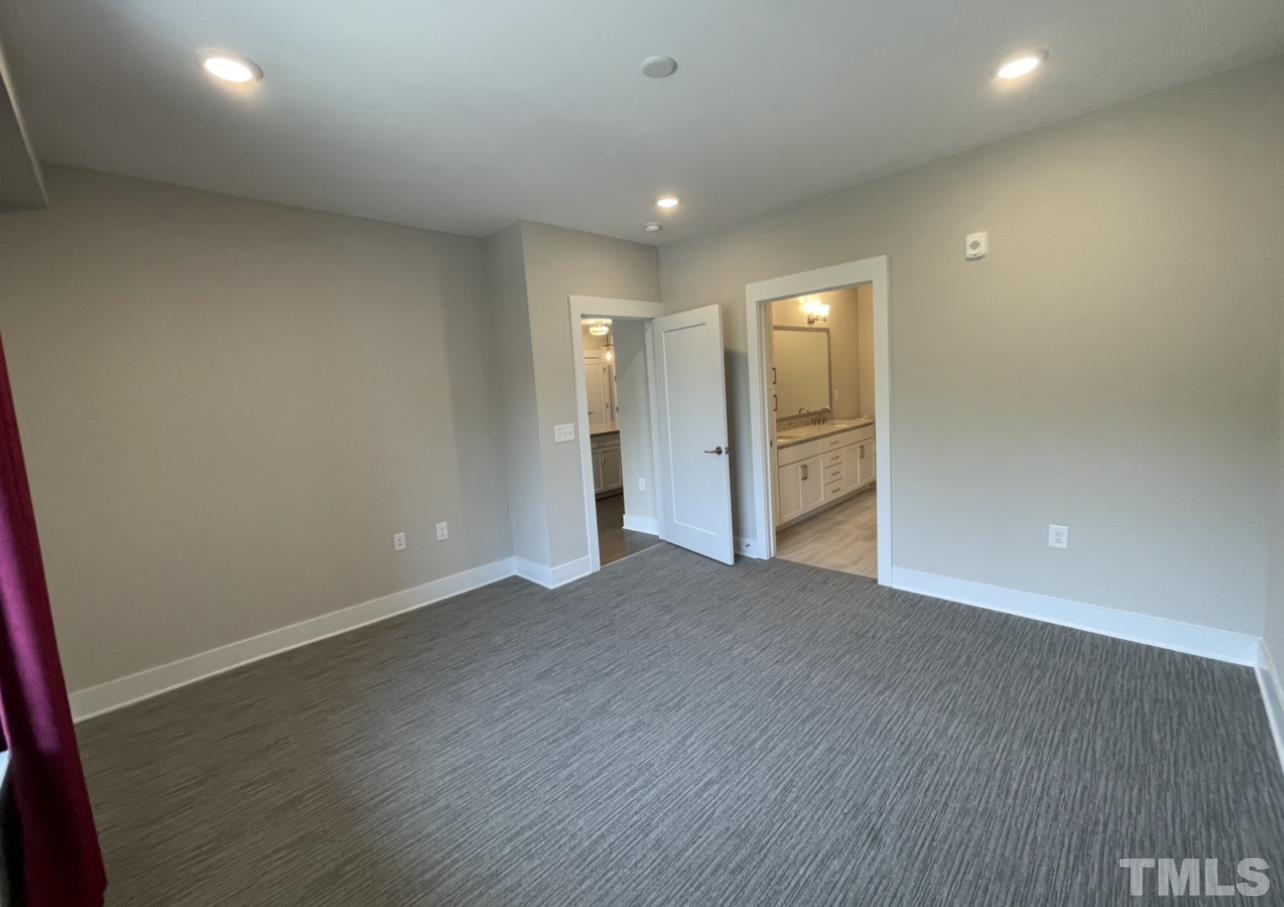 105 Chatham Walk Lane, Unit 404 Cary, NC 27511 - Photo 12 of 33 an empty room with wooden floor and windows