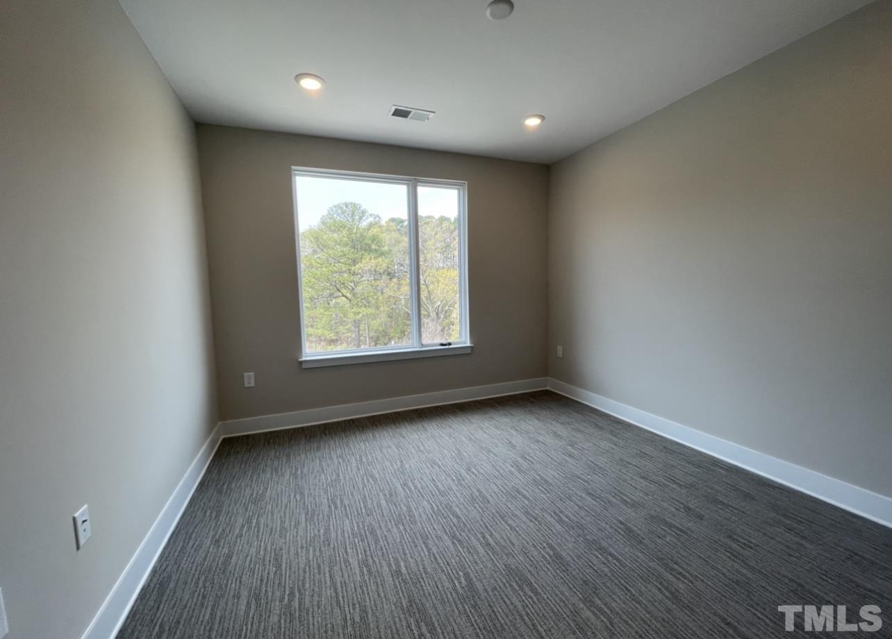 105 Chatham Walk Lane, Unit 404 Cary, NC 27511 - Photo 17 of 33 an empty room with wooden floor and windows