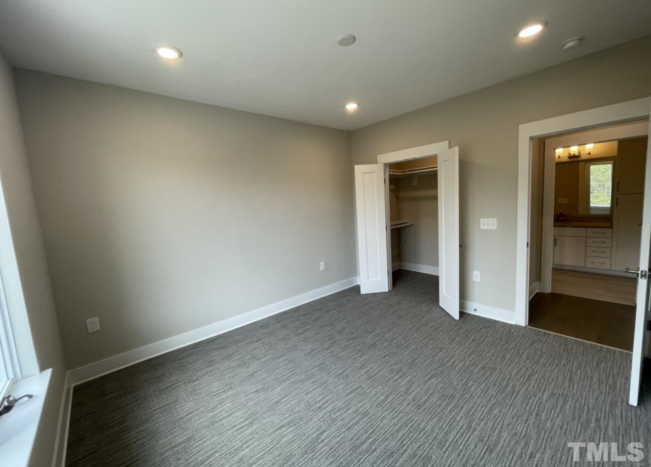 105 Chatham Walk Lane, Unit 404 Cary, NC 27511 - Photo 18 of 33 an empty room with wooden floor and en suite bathroom