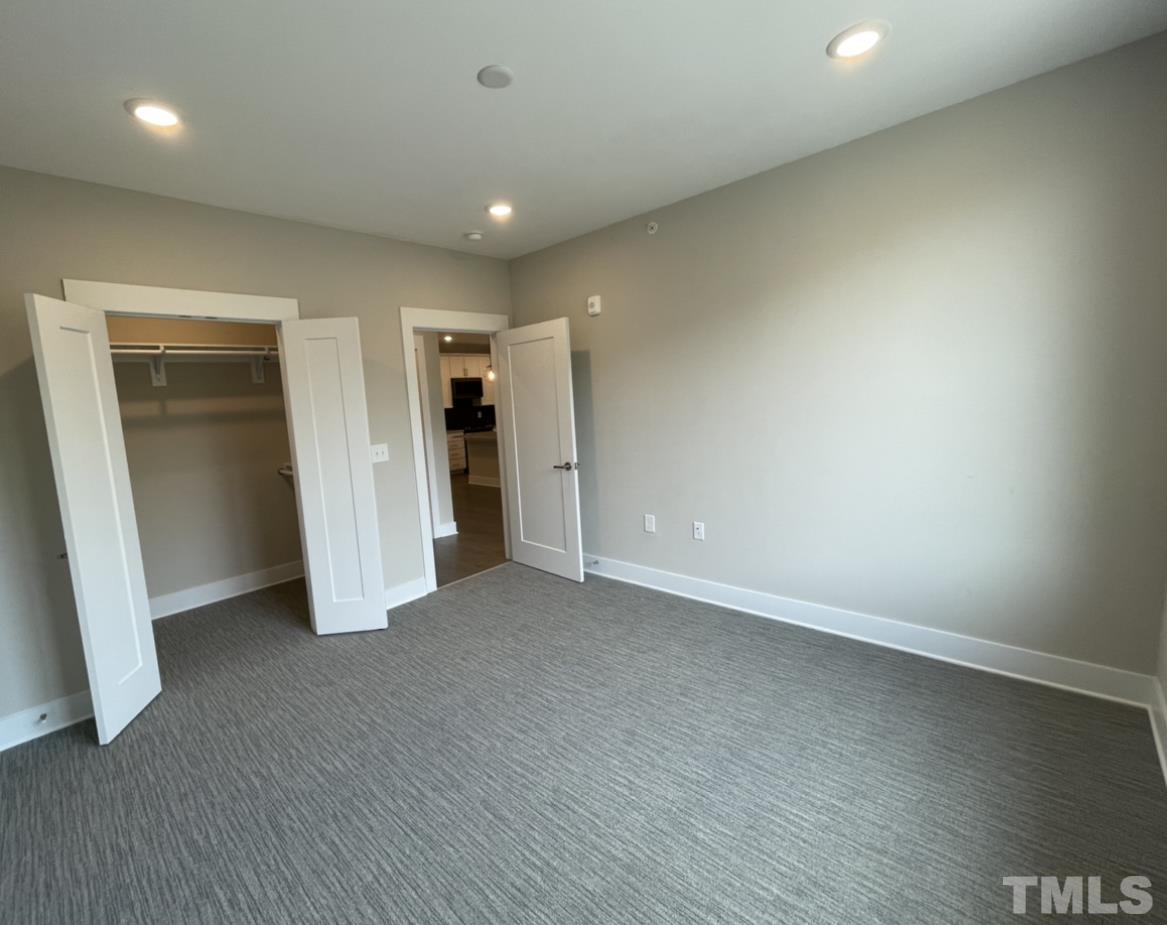 105 Chatham Walk Lane, Unit 404 Cary, NC 27511 - Photo 19 of 33 an empty room with closet and a bathroom