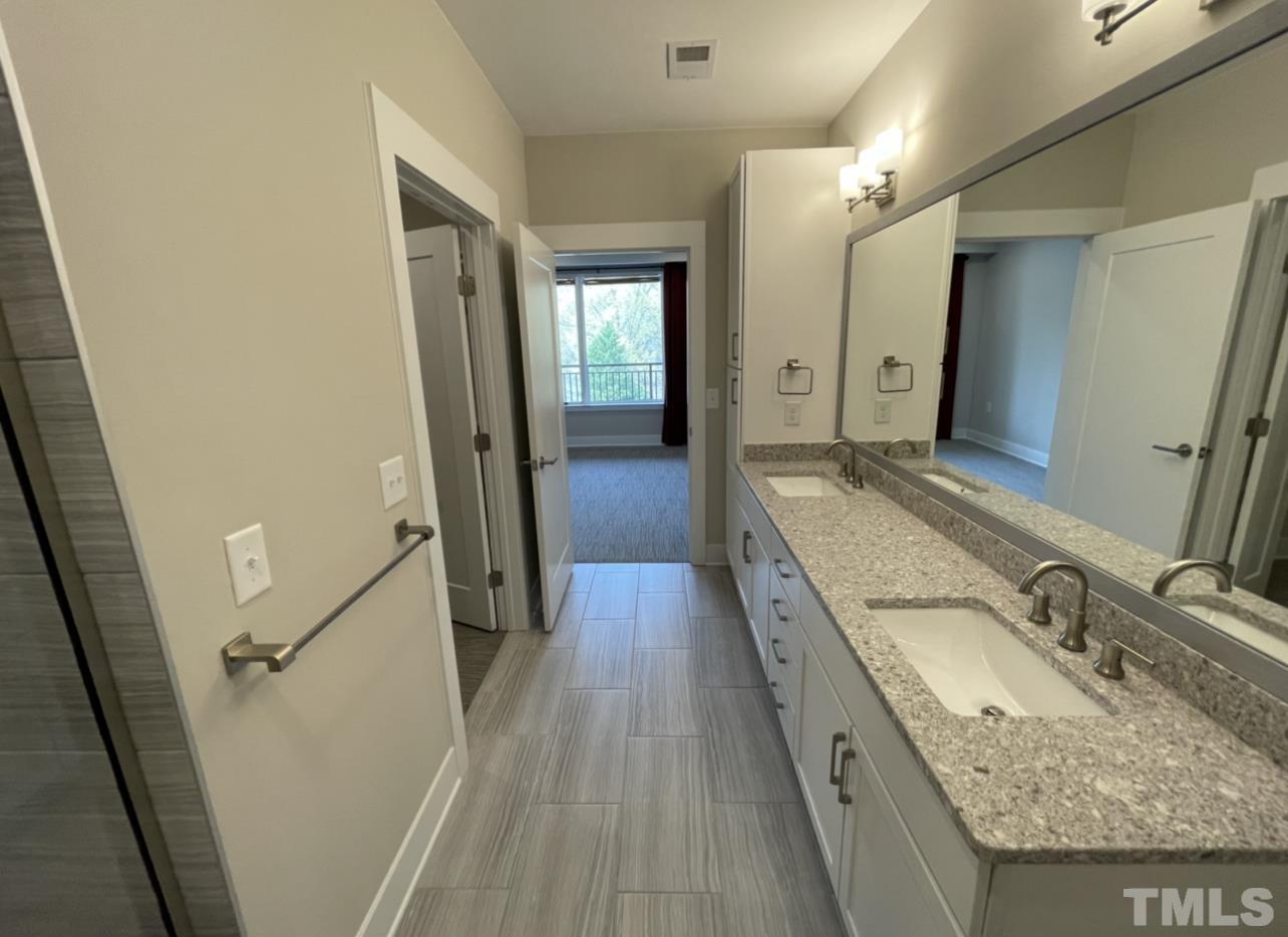 105 Chatham Walk Lane, Unit 404 Cary, NC 27511 - Photo 22 of 33 a bathroom with a granite countertop sink toilet and shower