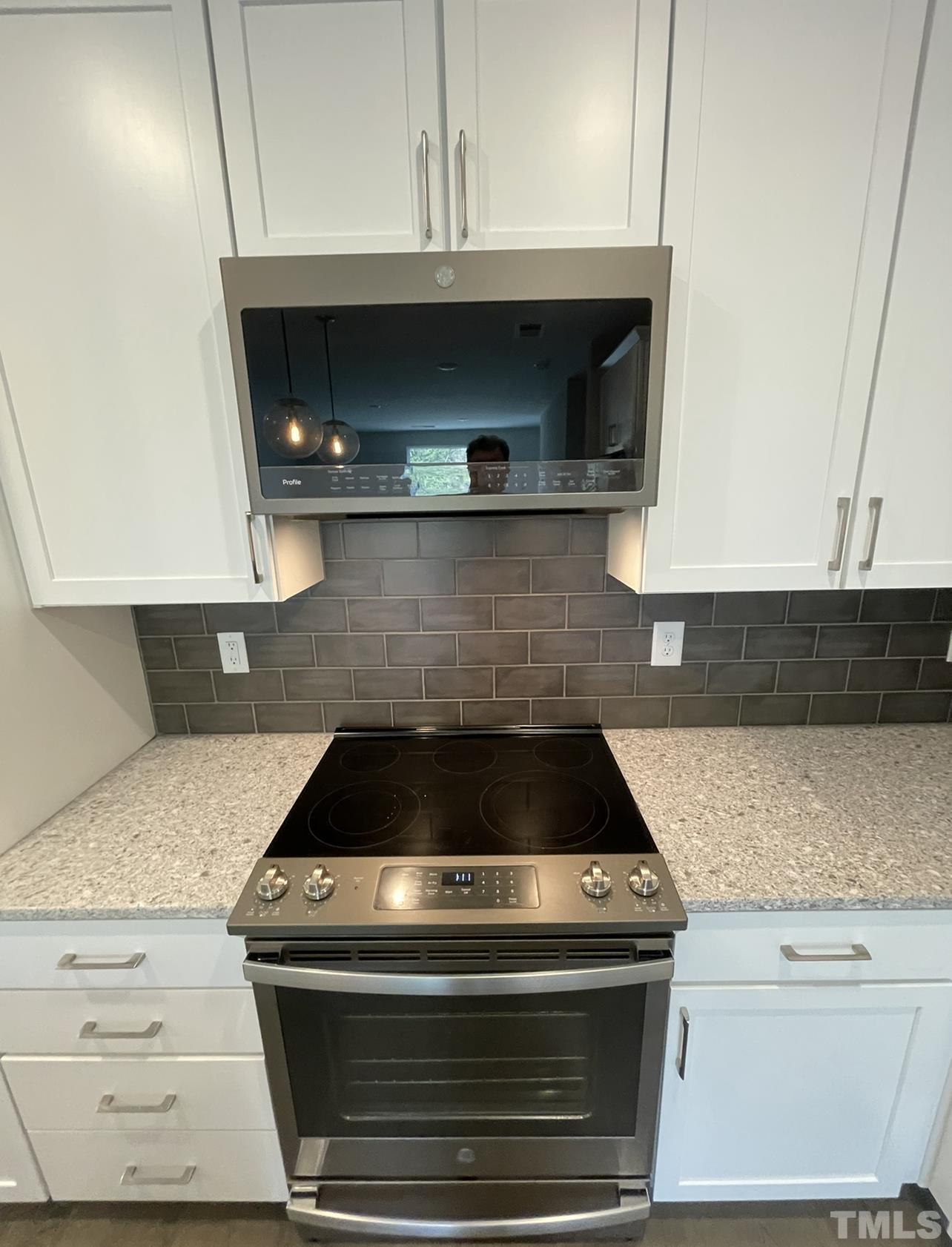 105 Chatham Walk Lane, Unit 404 Cary, NC 27511 - Photo 24 of 33 a stove top oven sitting inside of a kitchen