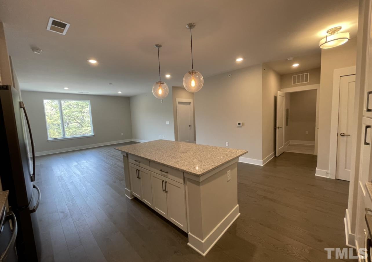 105 Chatham Walk Lane, Unit 404 Cary, NC 27511 - Photo 4 of 33 a kitchen with a stove and a wooden floor