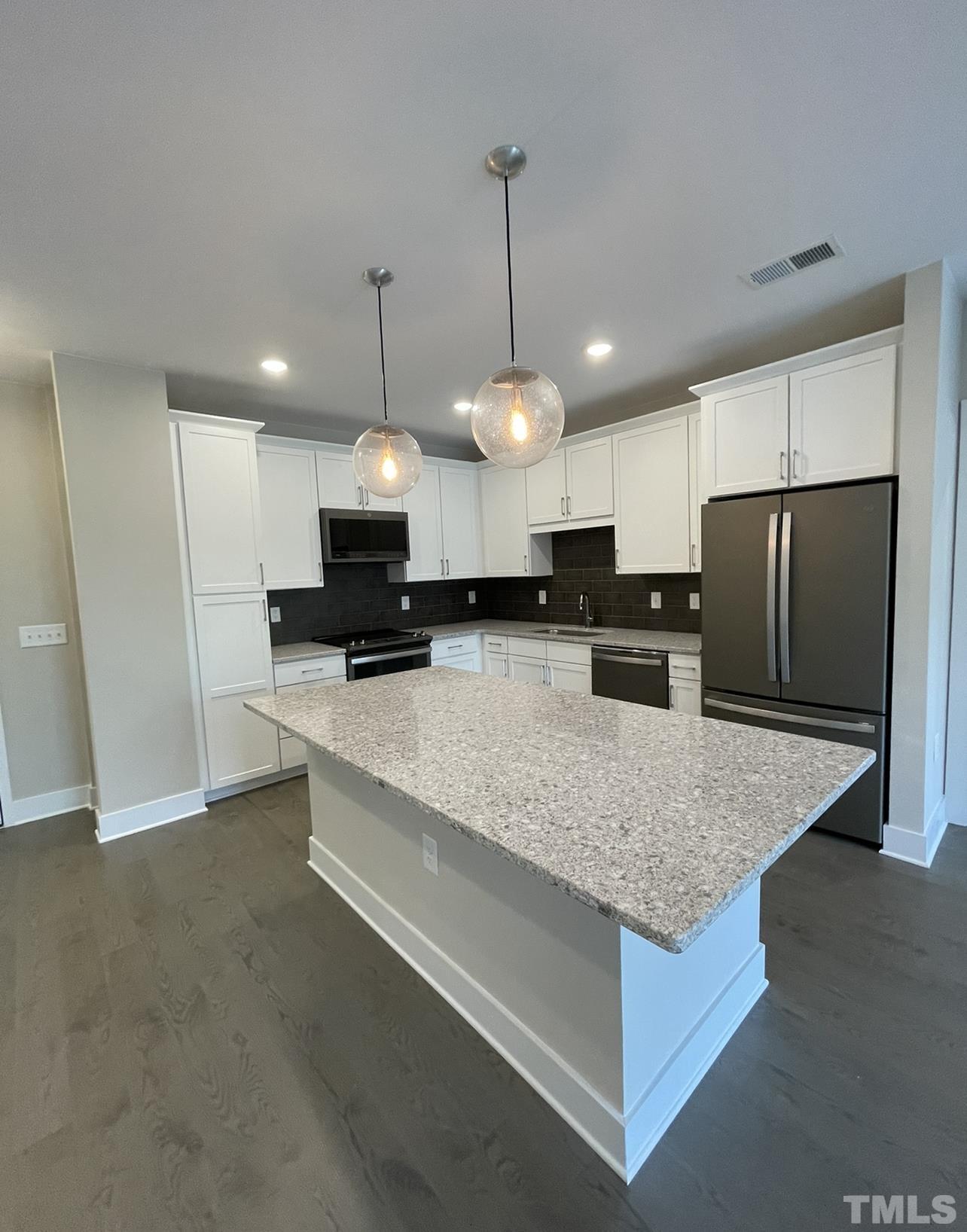 105 Chatham Walk Lane, Unit 404 Cary, NC 27511 - Photo 5 of 33 a large kitchen with kitchen island a large island in it