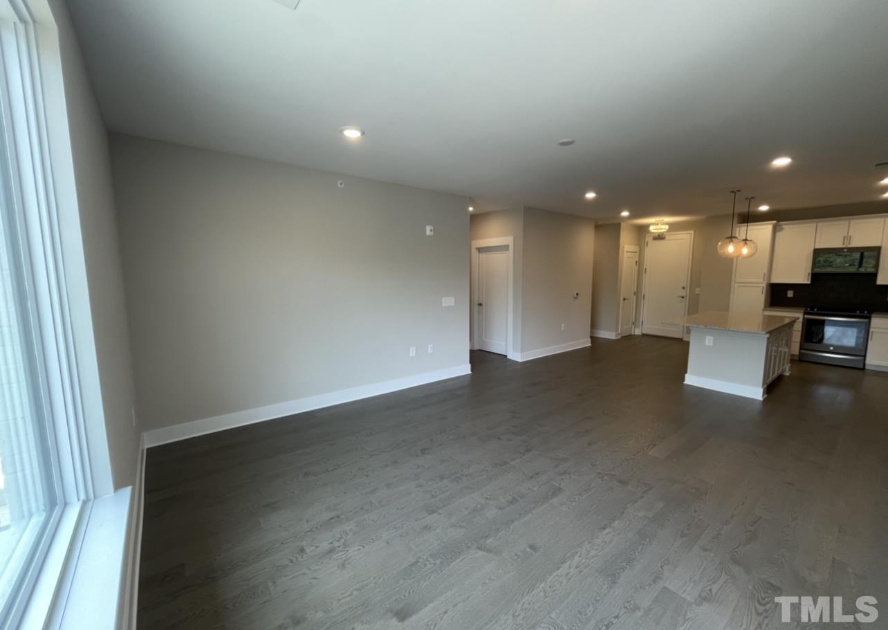 105 Chatham Walk Lane, Unit 404 Cary, NC 27511 - Photo 9 of 33 an empty room with wooden floor and windows