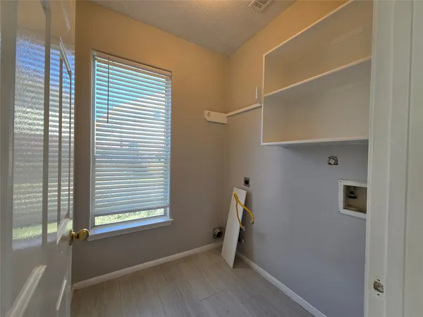 a view of room with window and wooden floor