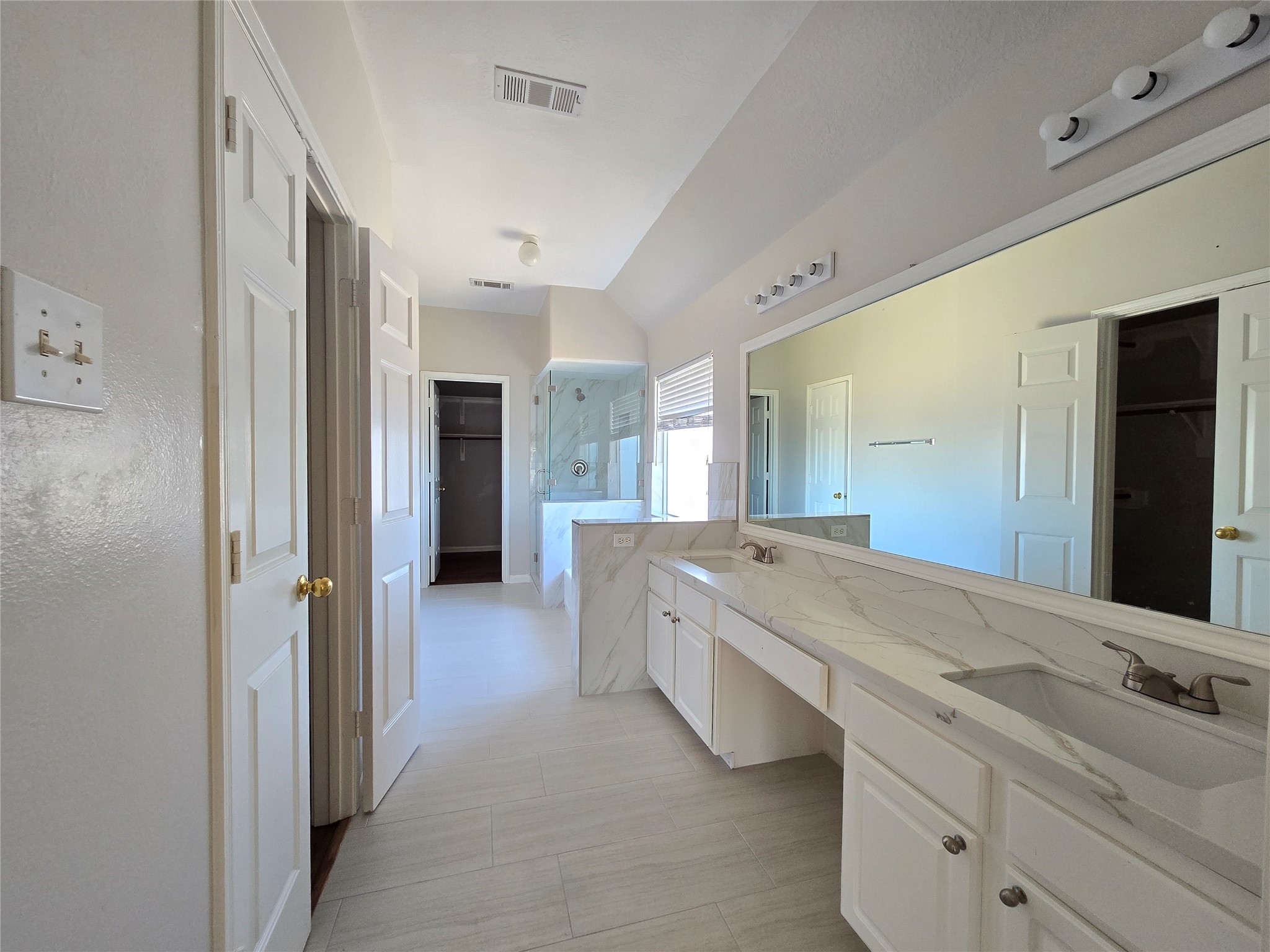 18819 Harbor Key Circle Houston, TX 77084 - Photo 18 of 33 a spacious bathroom with a granite countertop sink and a mirror