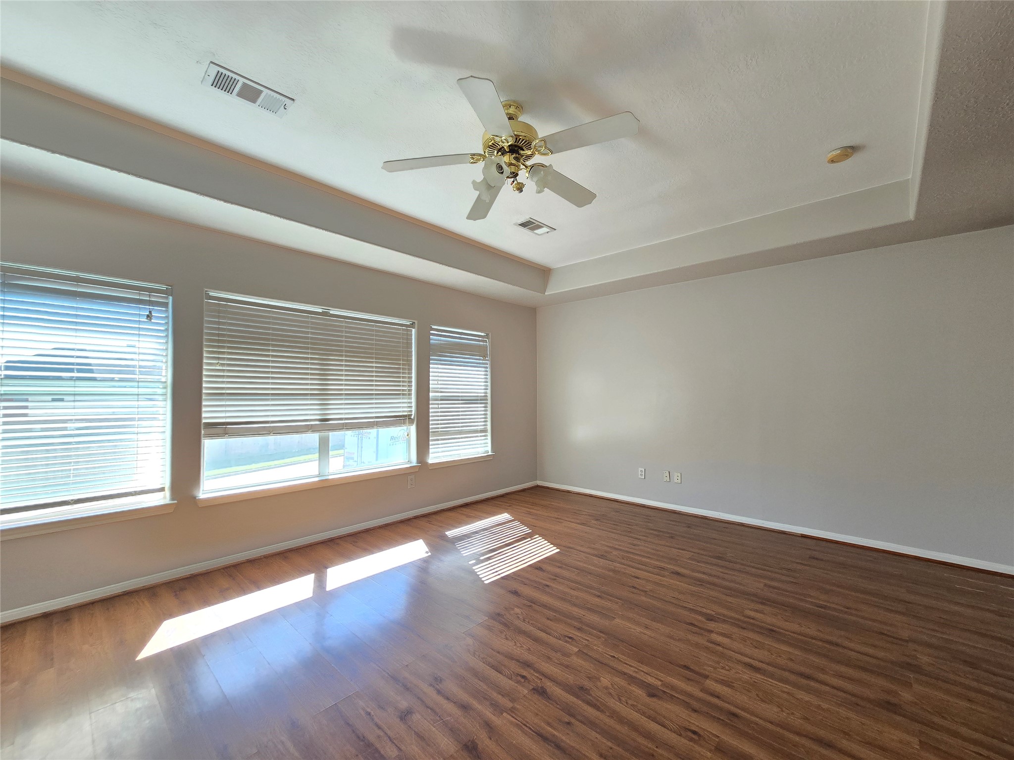 18819 Harbor Key Circle Houston, TX 77084 - Photo 21 of 33 a view of an empty room with wooden floor and a window