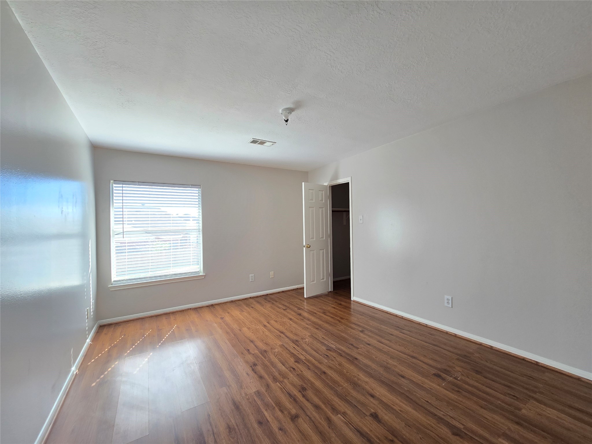 18819 Harbor Key Circle Houston, TX 77084 - Photo 22 of 33 an empty room with wooden floor and windows