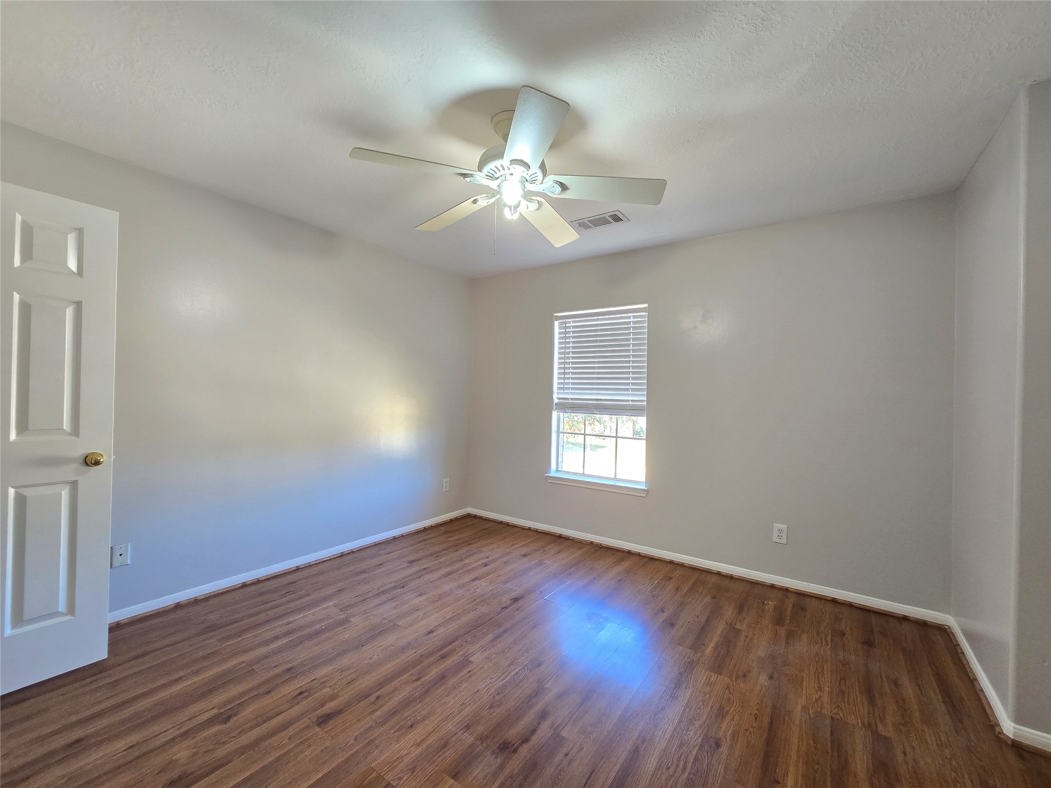 18819 Harbor Key Circle Houston, TX 77084 - Photo 24 of 33 a view of an empty room with wooden floor and a window