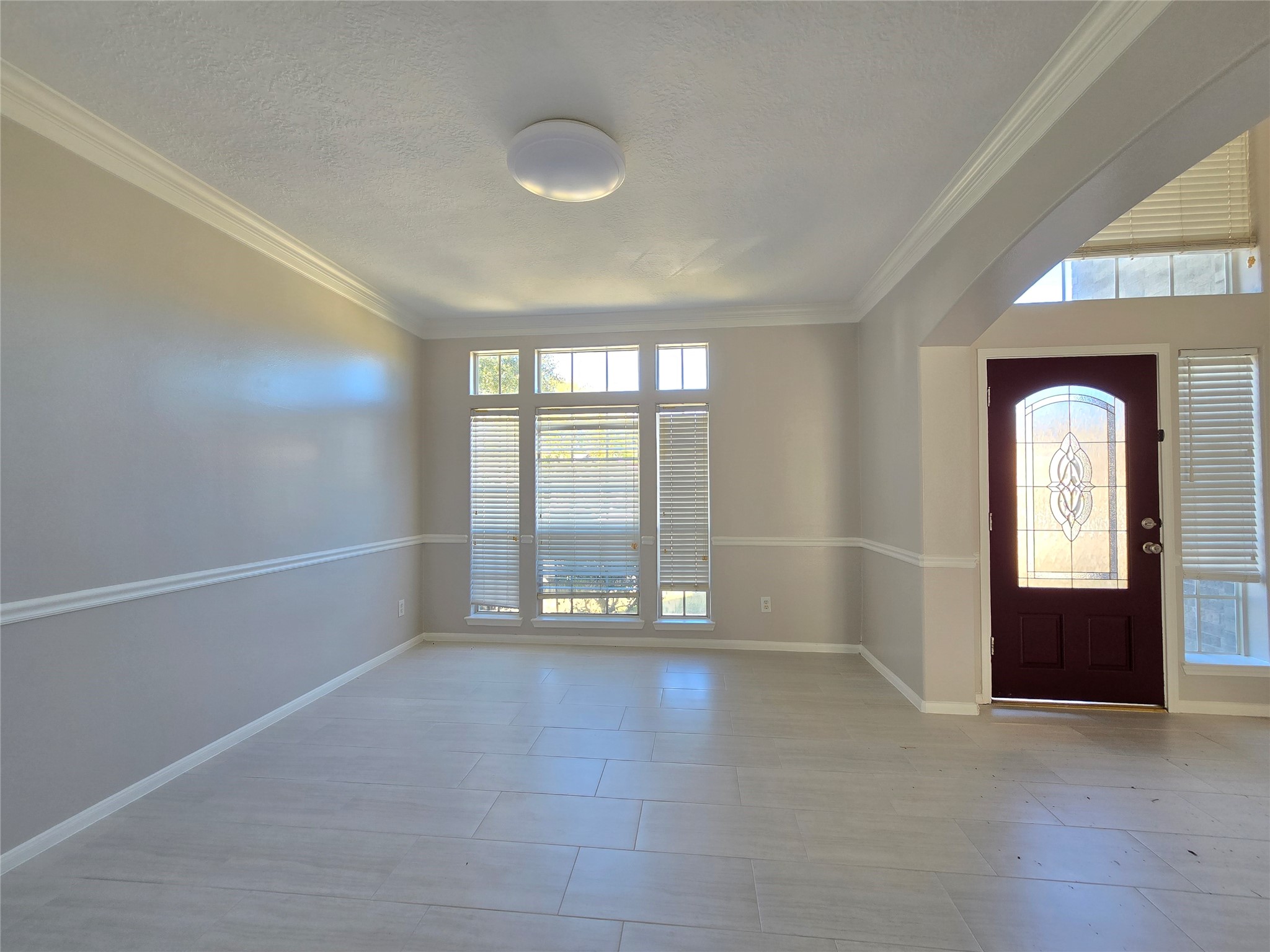 18819 Harbor Key Circle Houston, TX 77084 - Photo 3 of 33 an empty room with floor to ceiling windows